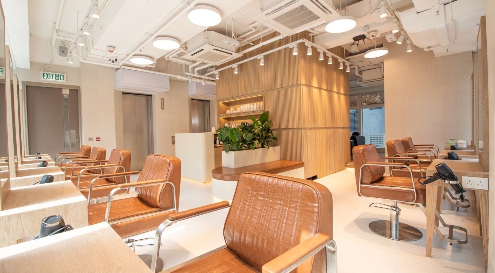Modern interior of Lashicu Hair Design on Hong Kong Island, featuring stylish chairs and natural lighting.