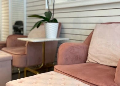 Elegant seating area at View Beauty Salon and Spa in Vancouver, British Columbia, CA with plush pink chairs.