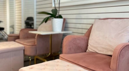 Elegant seating area at View Beauty Salon and Spa in Vancouver, British Columbia, CA with plush pink chairs.