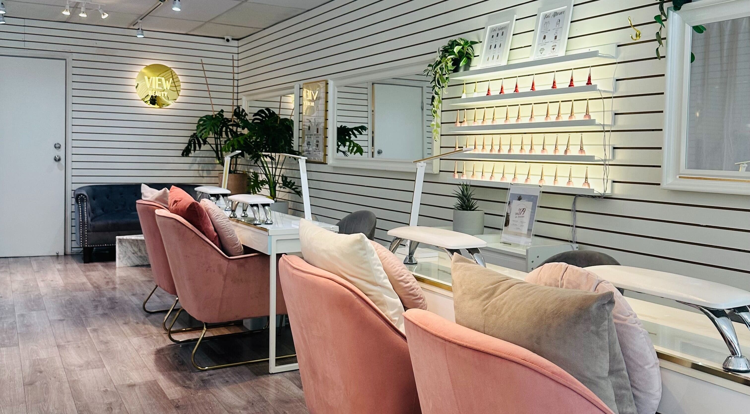 Chic interior of View Beauty Salon and Spa, Vancouver, British Columbia, CA with plush seating and nail polish display.