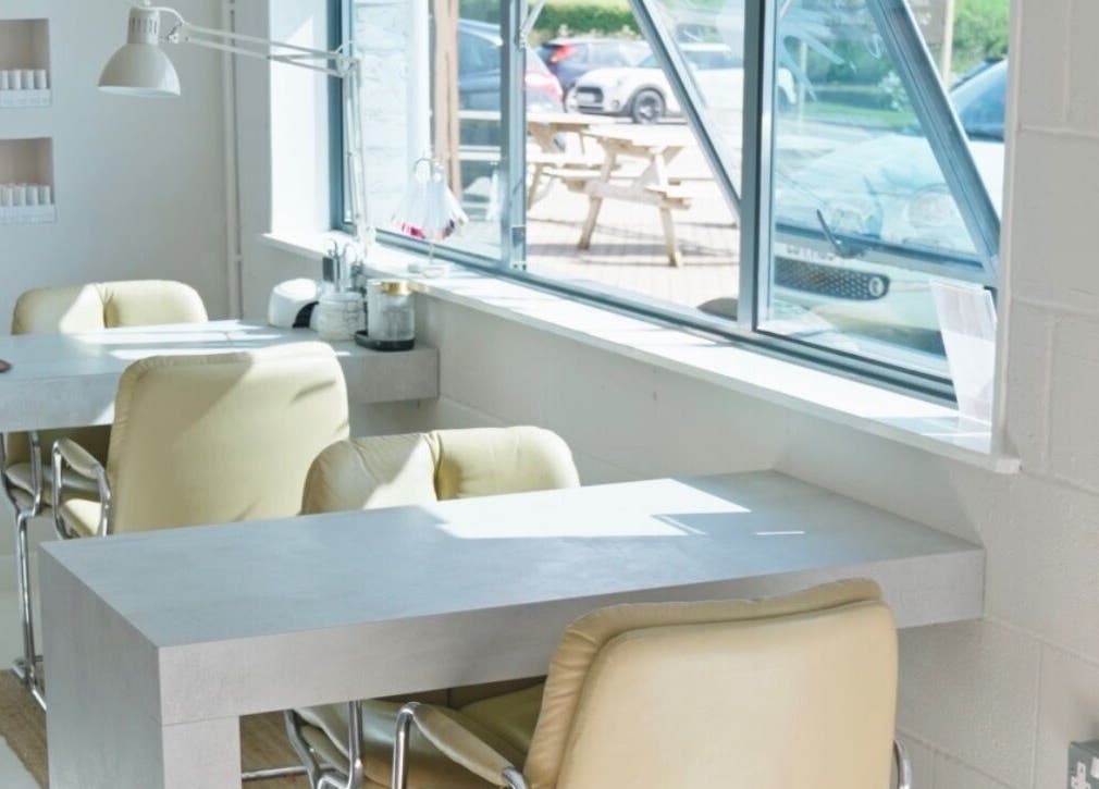 Bright nail salon interior at Liwa Nails, Wadebridge, England, GB with cozy seating and natural light.