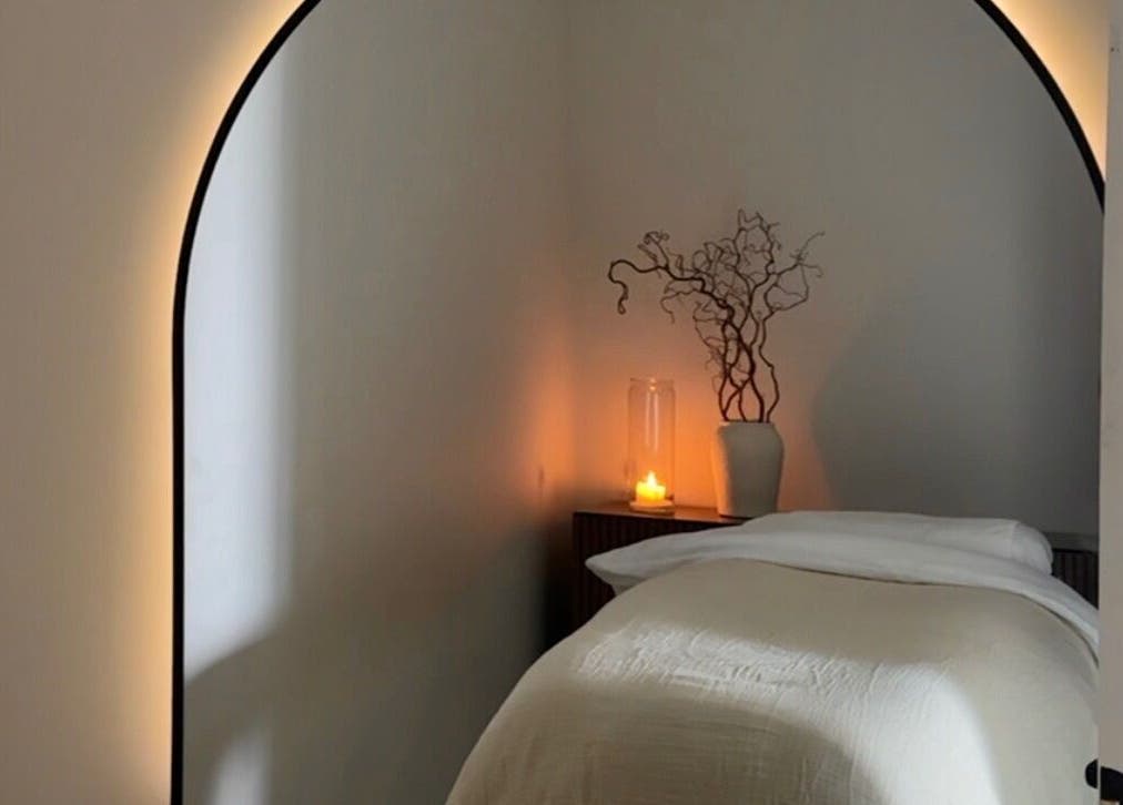 Serene massage room at Liwa Nails, Wadebridge, England, GB, featuring a cozy bed and ambient lighting.