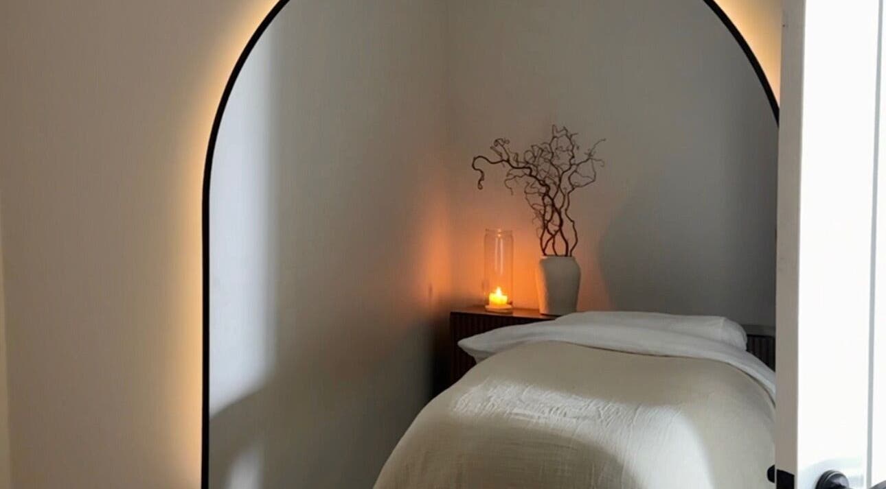 Serene massage room at Liwa Nails, Wadebridge, England, GB, featuring a cozy bed and ambient lighting.