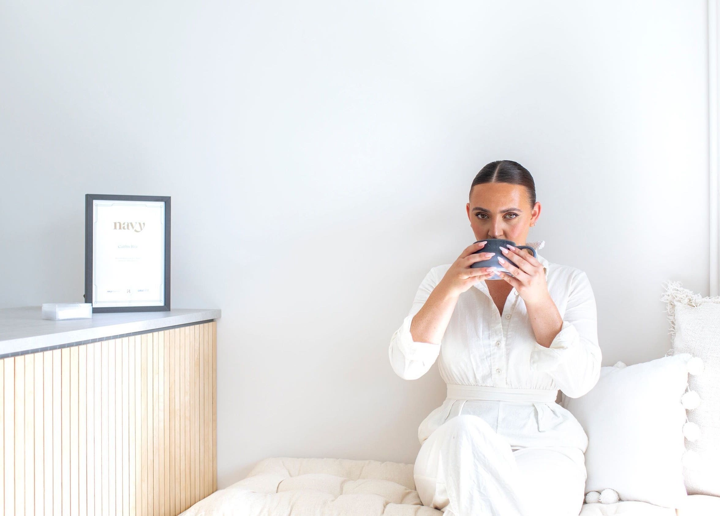 Woman relaxing with a cup at Liwa nails, Wadebridge, England, GB, embodying serenity and elegance.