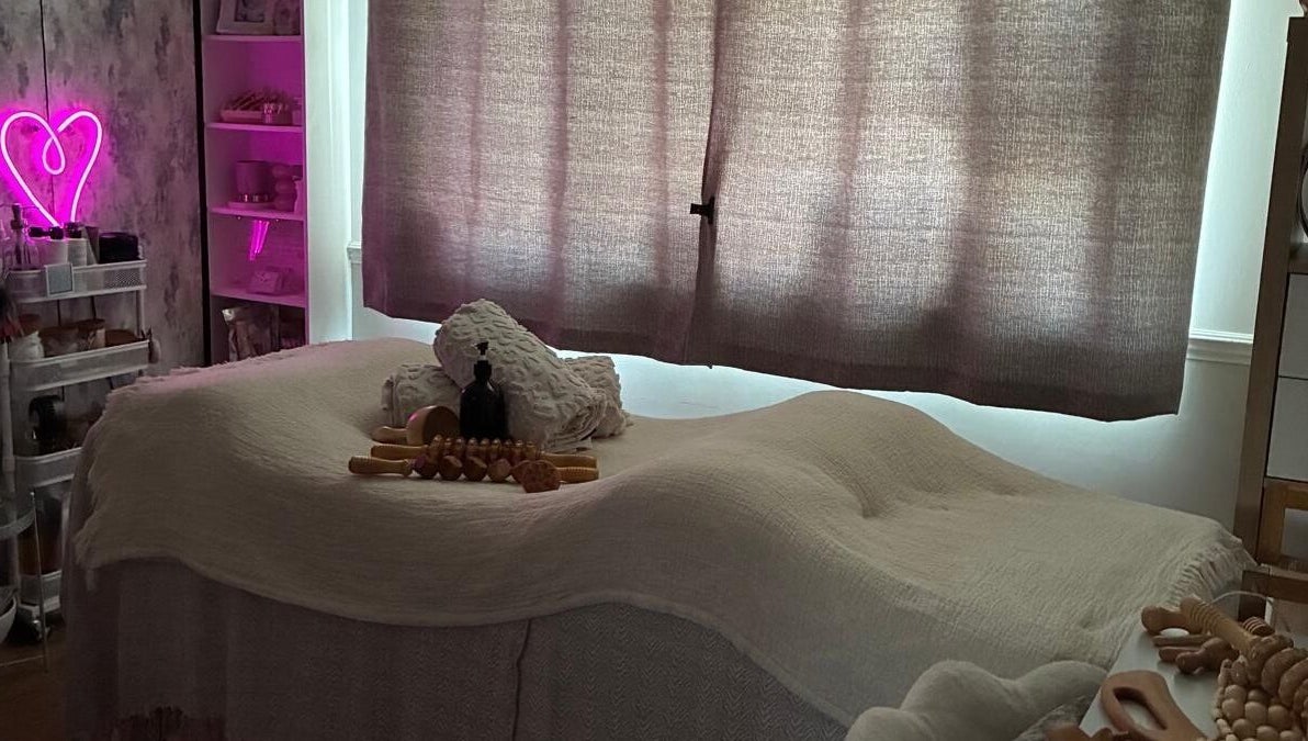 Cozy massage room at NAHLA Studio, Slough, England, GB with soft lighting and wellness decor.