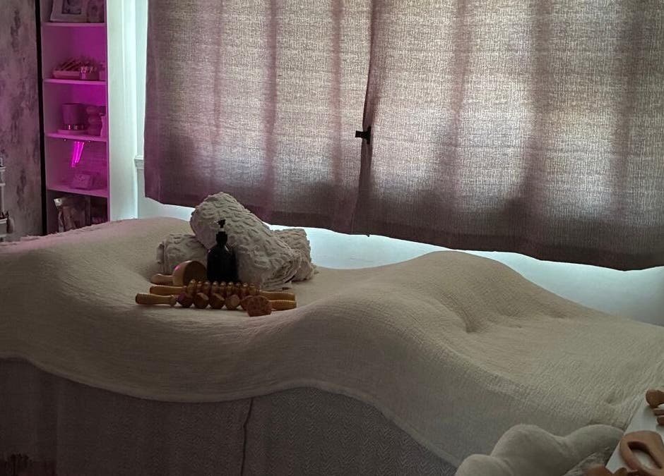 Cozy massage room at NAHLA Studio, Slough, England, GB with soft lighting and wellness decor.