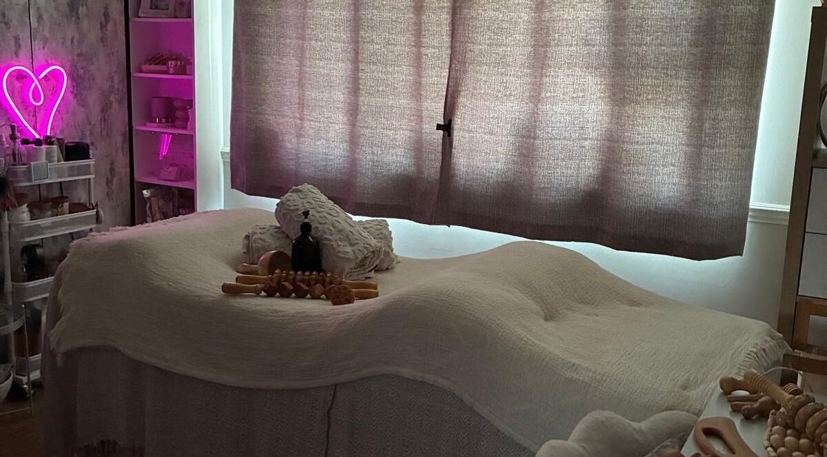 Cozy massage room at NAHLA Studio, Slough, England, GB with soft lighting and wellness decor.