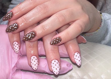 Stylish brown and pink dotted nails at NAHLA Studio, Slough, England, GB, showcasing expert nail design.