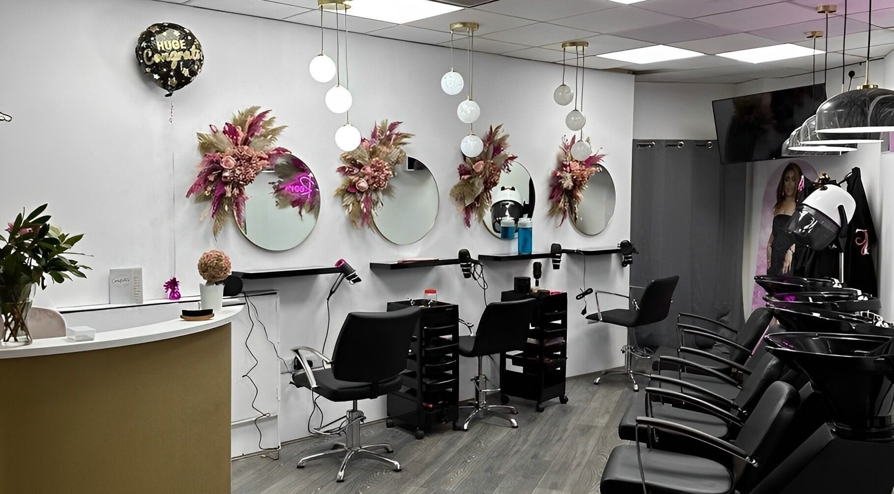 Interior of Toy’s Hair and Beauty, Manchester, England, GB, featuring elegant salon stations and modern decor.