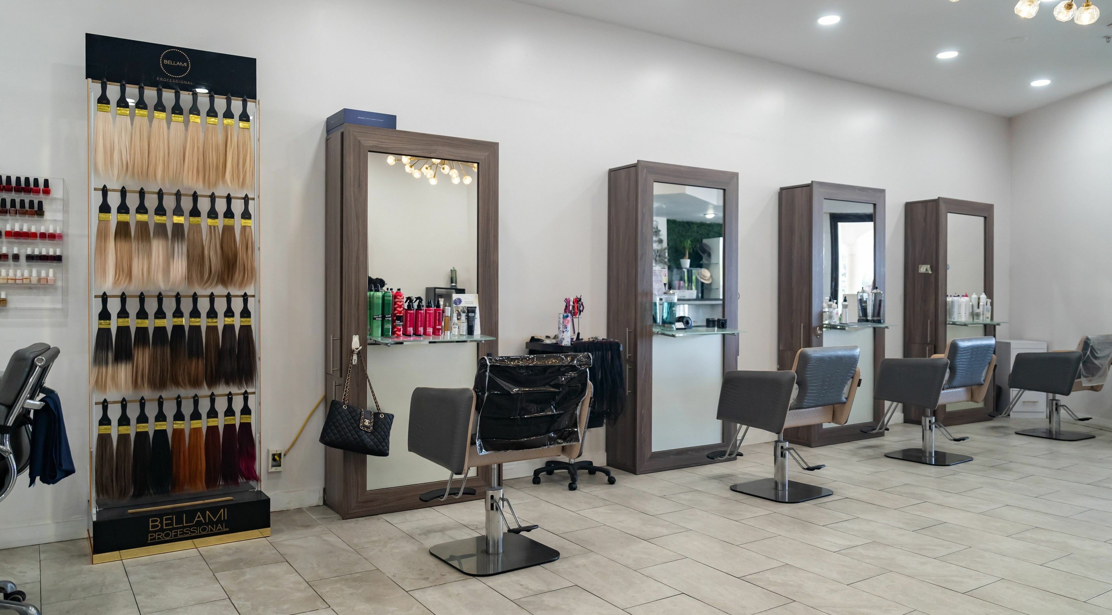 Interior of Le Salon in Manalapan, Florida, featuring chic styling stations and hair products display.