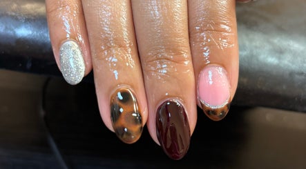 Elegant nail art at Eala Beauty, Northern Ireland showcasing glitter, tortoiseshell, and pink designs.