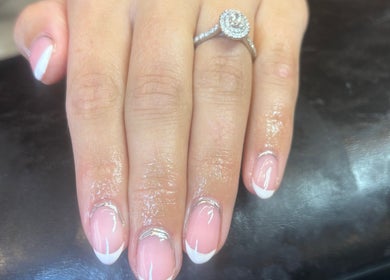 Elegant French manicure with a diamond ring at Eala Beauty, Northern Ireland, GB.