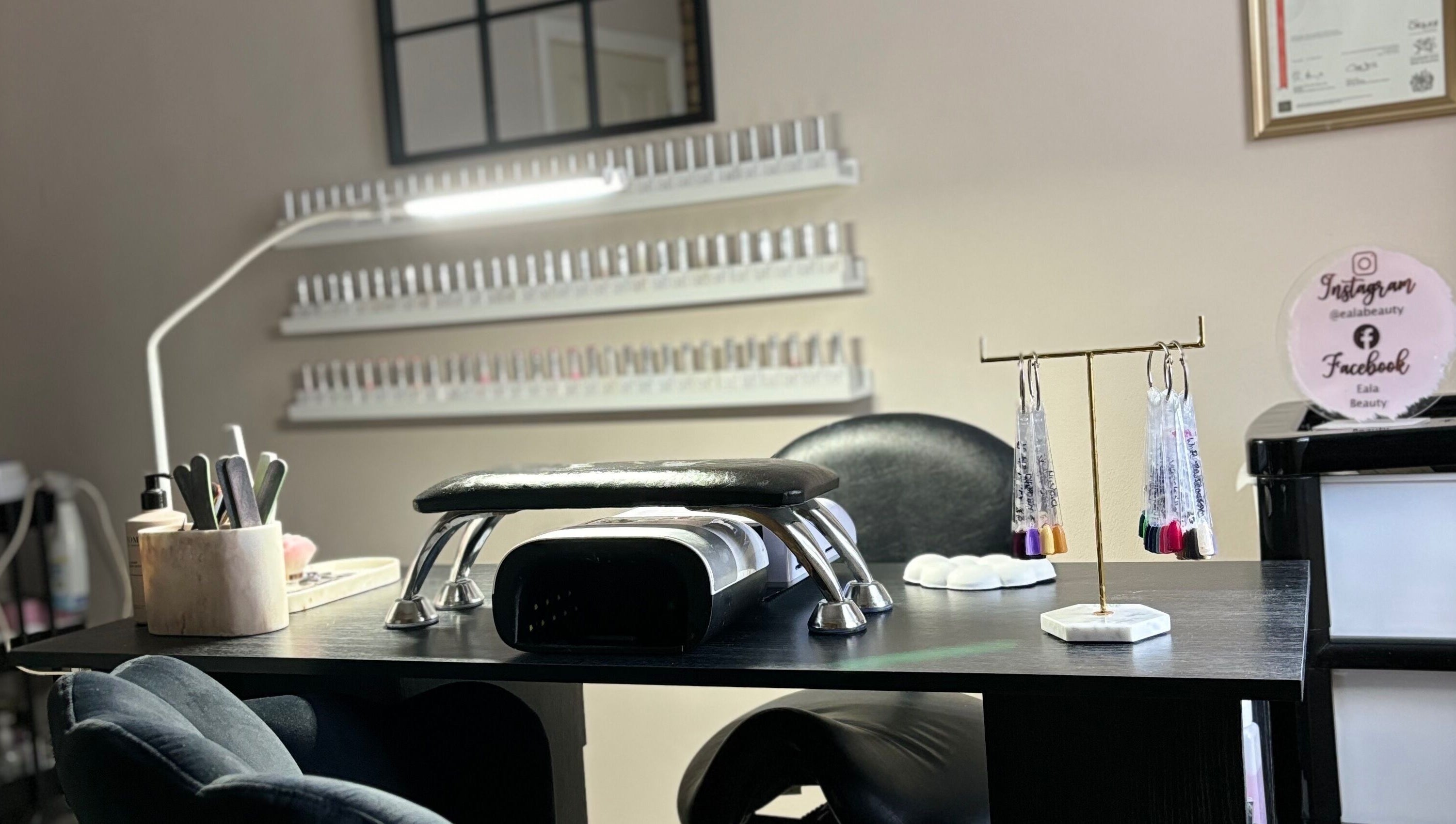 Nail station at Eala Beauty, Northern Ireland, showcasing manicure tools and vibrant polishes.