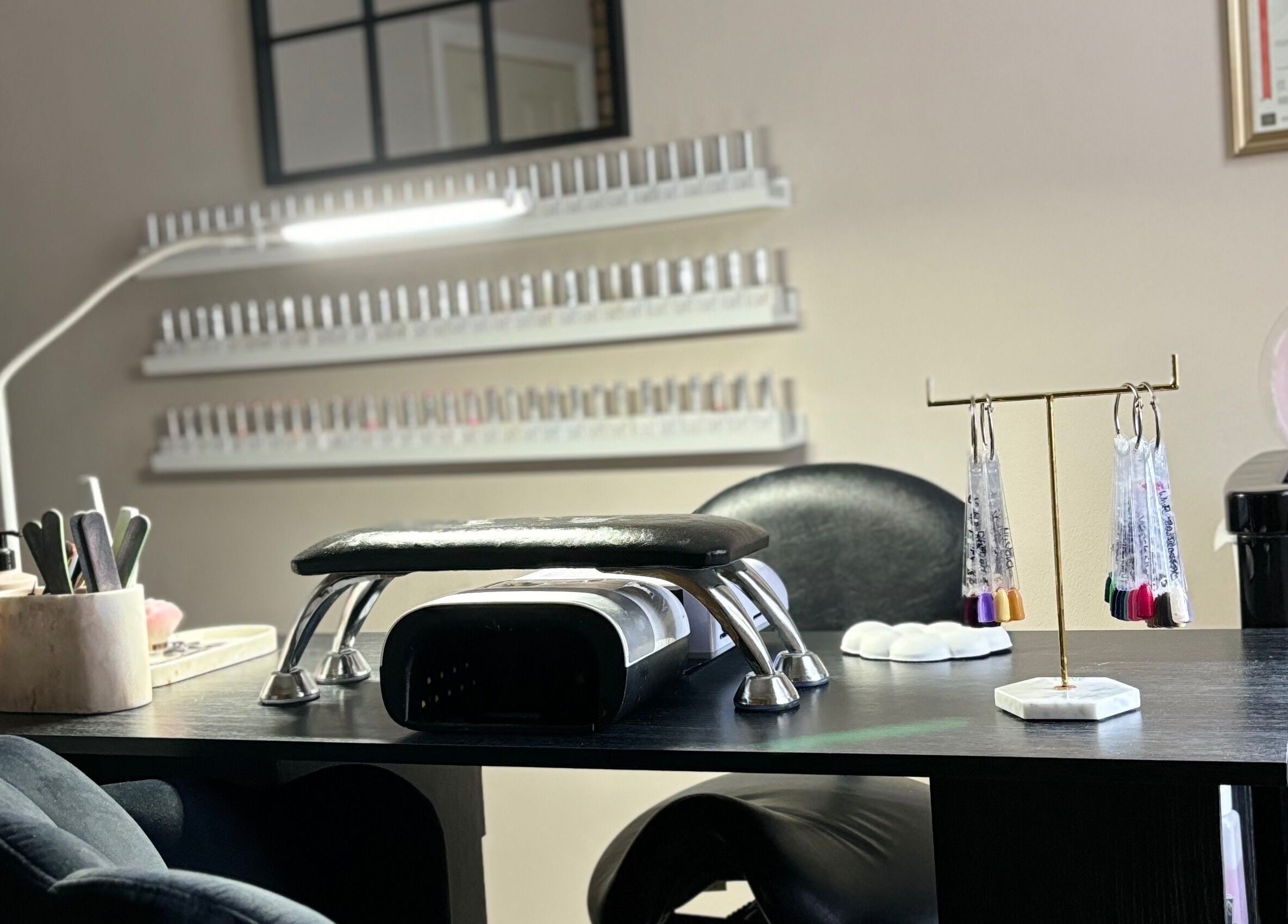 Nail station at Eala Beauty, Northern Ireland, showcasing manicure tools and vibrant polishes.