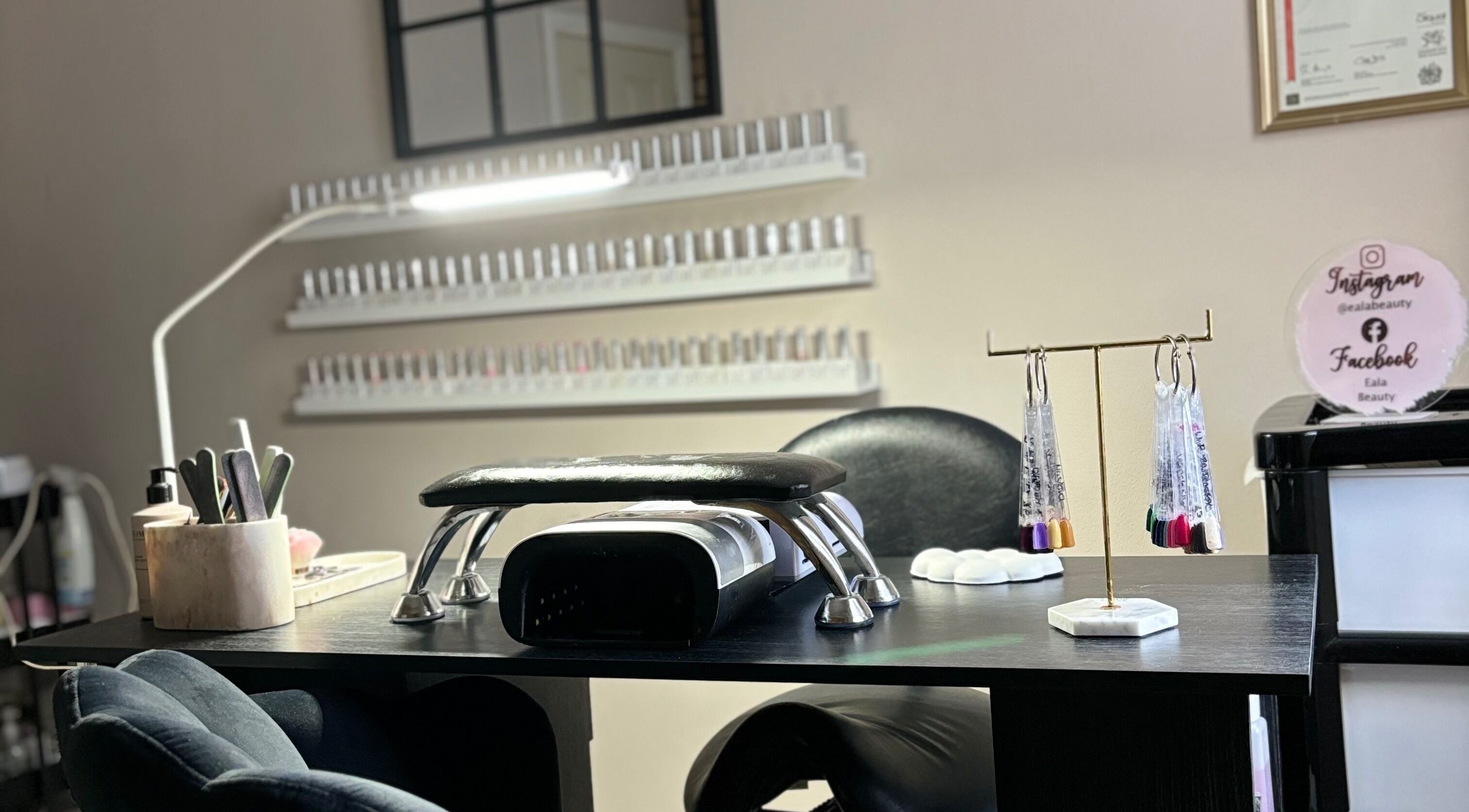 Nail station at Eala Beauty, Northern Ireland, showcasing manicure tools and vibrant polishes.