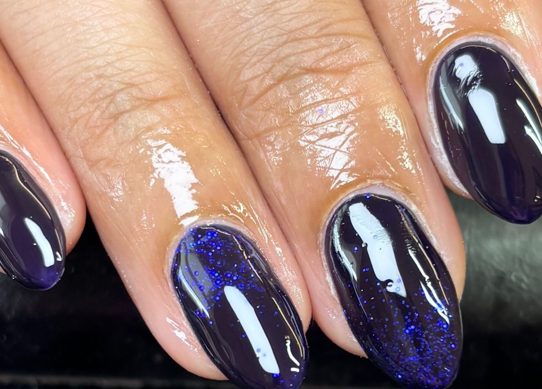 Elegant dark purple gel nails with glitter at Eala Beauty, Northern Ireland, Northern Ireland, GB.