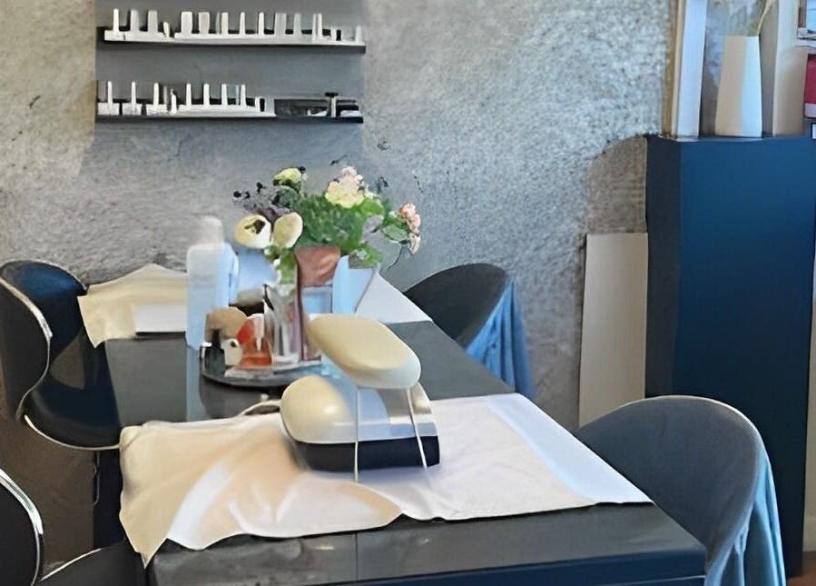 Elegant nail care setup at The Beauty Spot, Birmingham, England, GB, featuring chic chairs and floral decor.