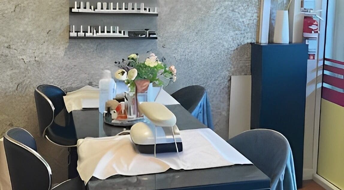 Elegant nail care setup at The Beauty Spot, Birmingham, England, GB, featuring chic chairs and floral decor.