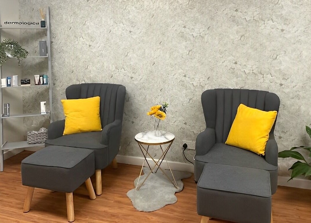 Relaxing seating area with gray chairs and yellow accents at The Beauty Spot, Birmingham, England, GB.