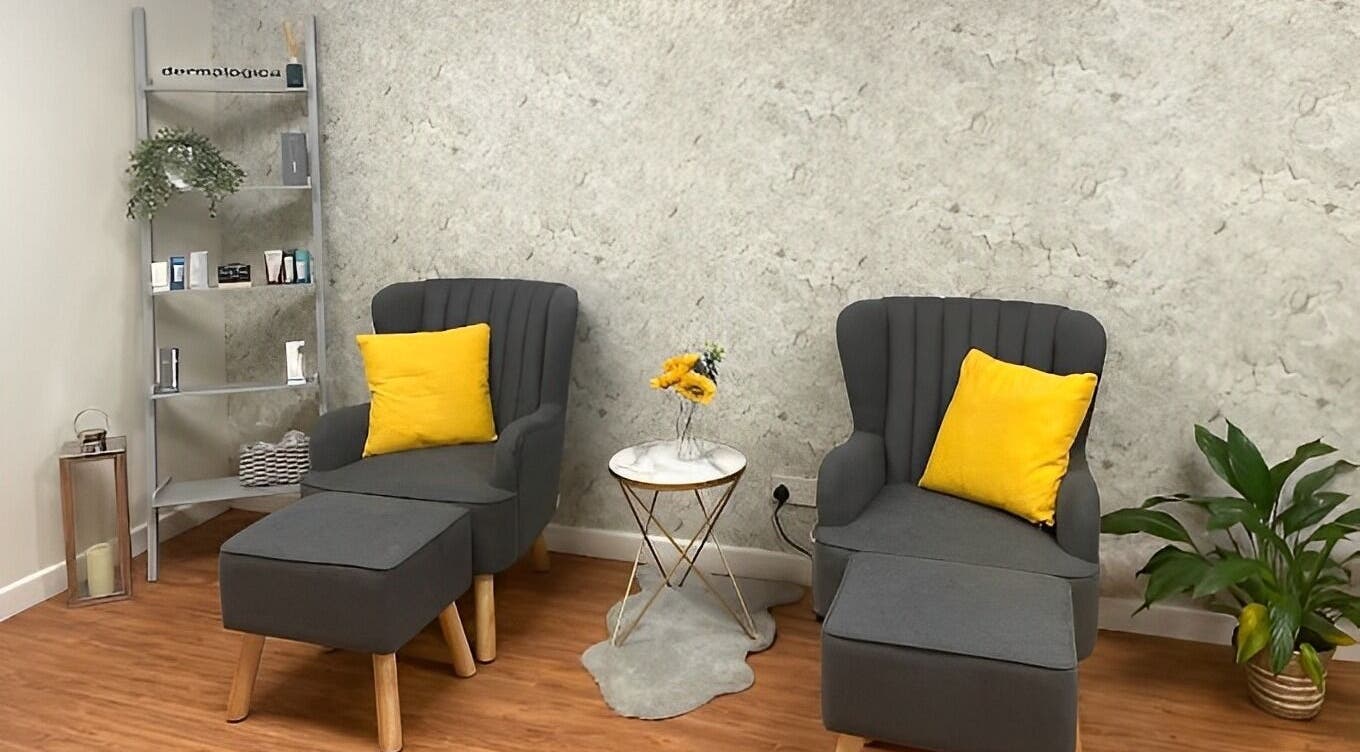 Relaxing seating area with gray chairs and yellow accents at The Beauty Spot, Birmingham, England, GB.
