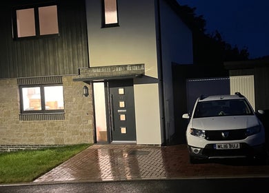 Exterior view of Fletcher Beauty in Lanner, England, showcasing modern design at night with parked car.