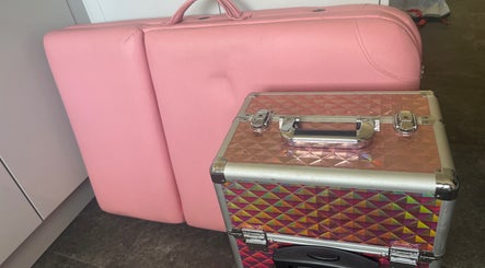 Pink massage table and shimmering case at Fletcher Beauty, Lanner, England, GB.