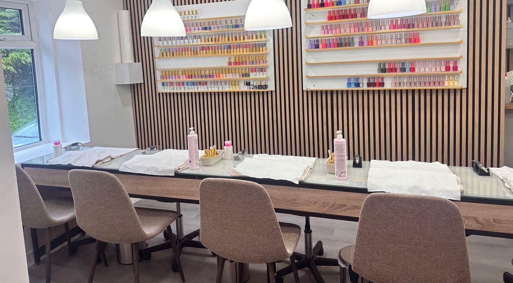 Elegant nail station at Lotus Nail Stillorgan in Dublin, County Dublin, IE, with natural lighting and polish colors.