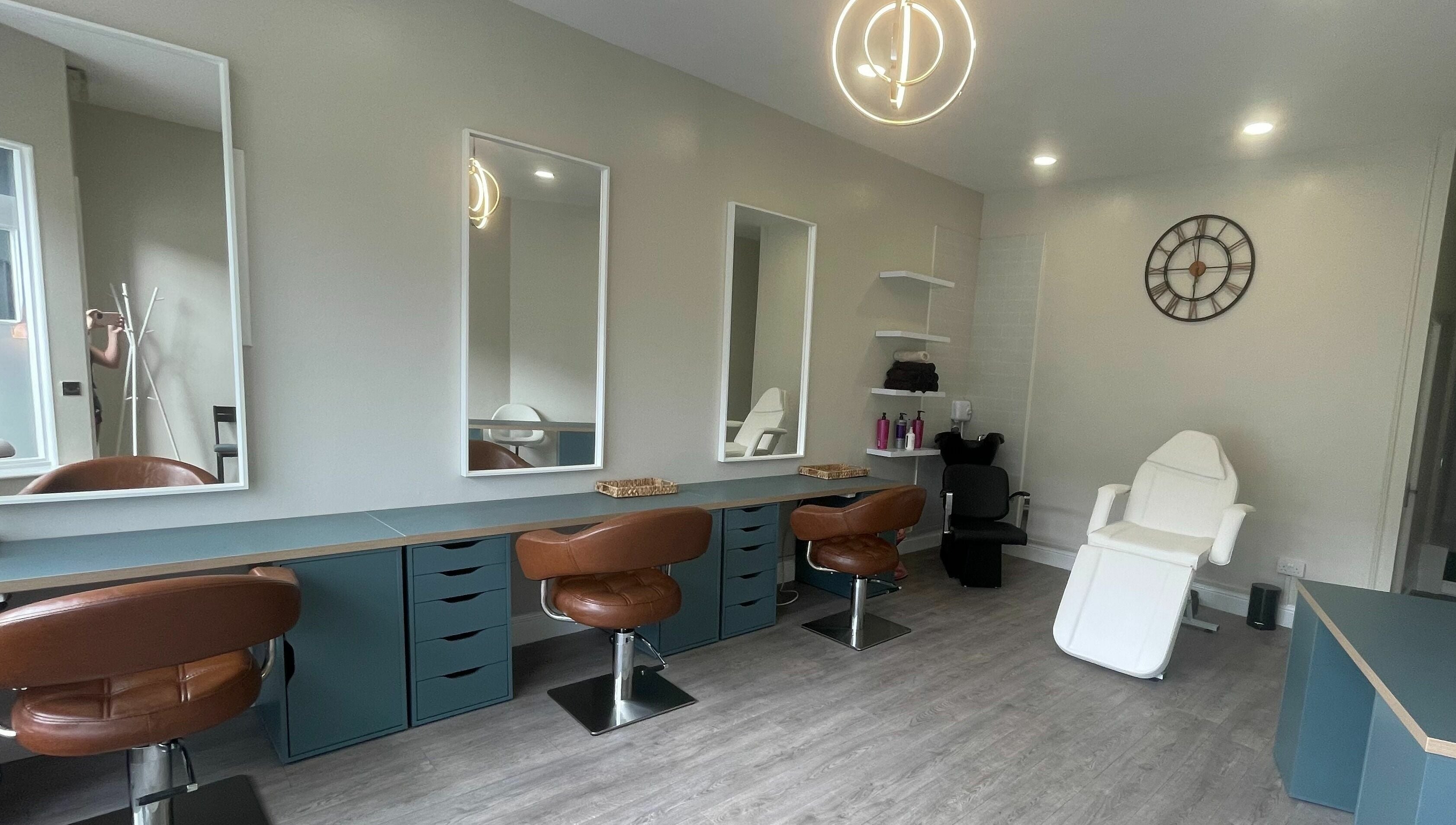 Modern salon interior at Colours Falkirk, Falkirk, Scotland, GB, featuring stylish chairs and mirrors.