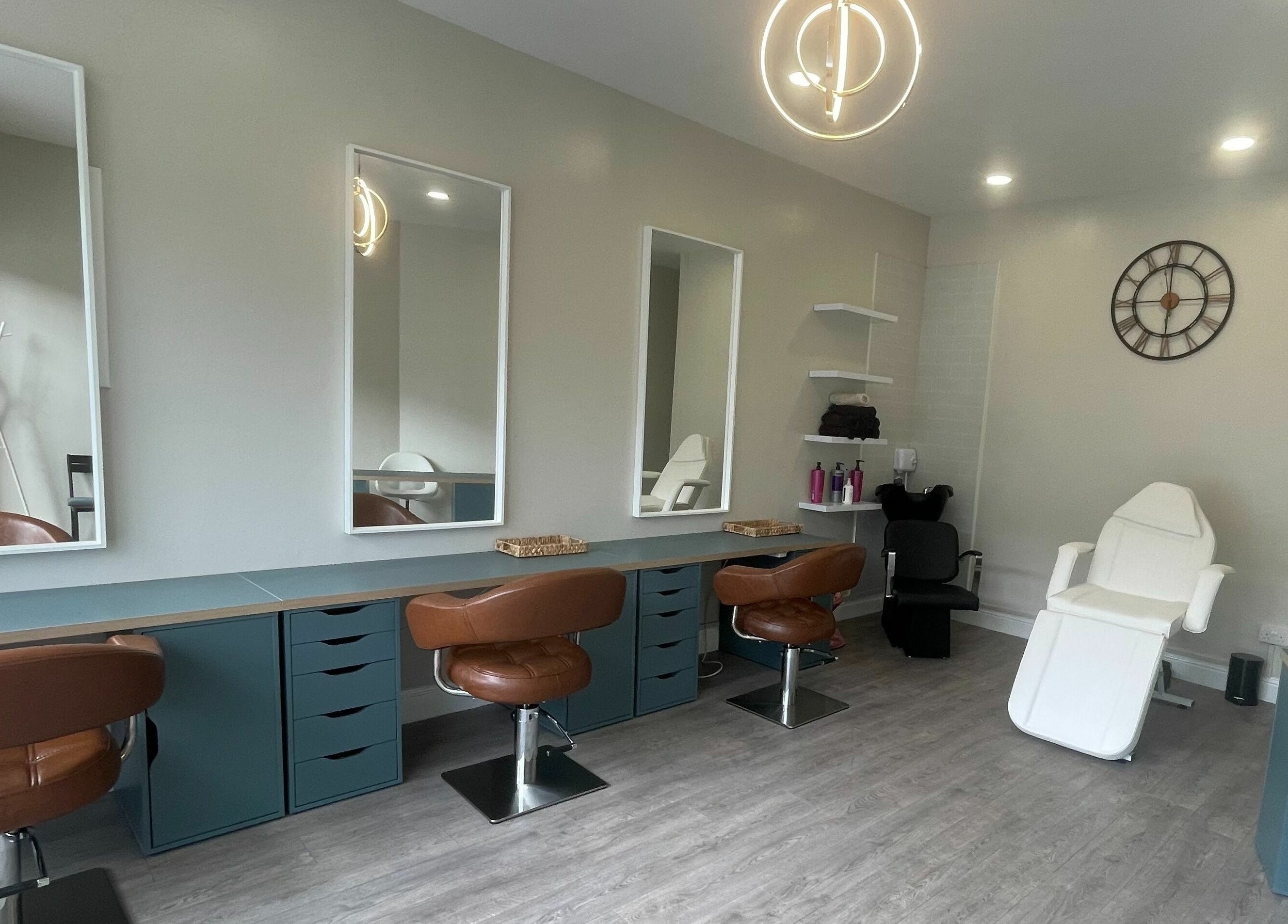Modern salon interior at Colours Falkirk, Falkirk, Scotland, GB, featuring stylish chairs and mirrors.
