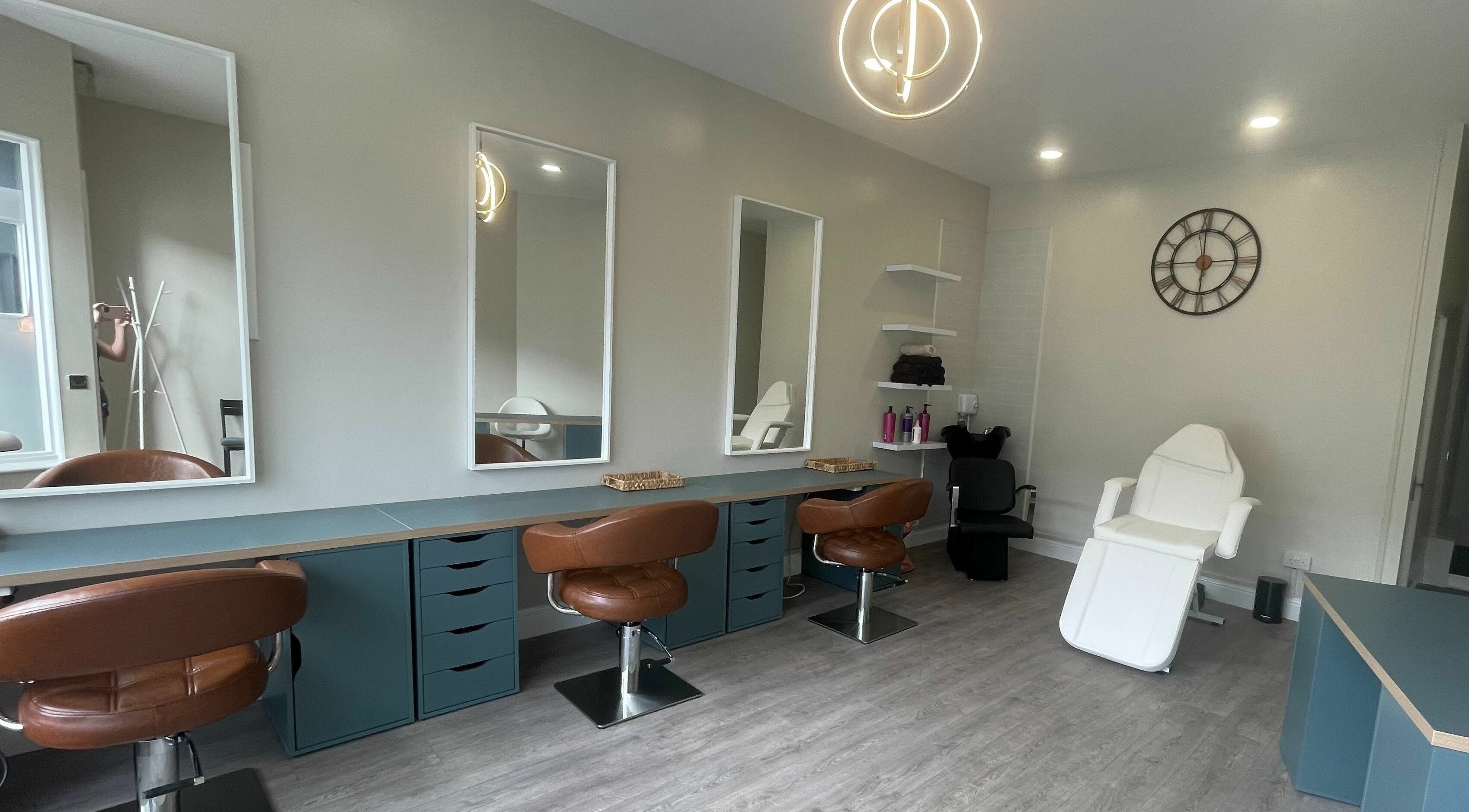 Modern salon interior at Colours Falkirk, Falkirk, Scotland, GB, featuring stylish chairs and mirrors.