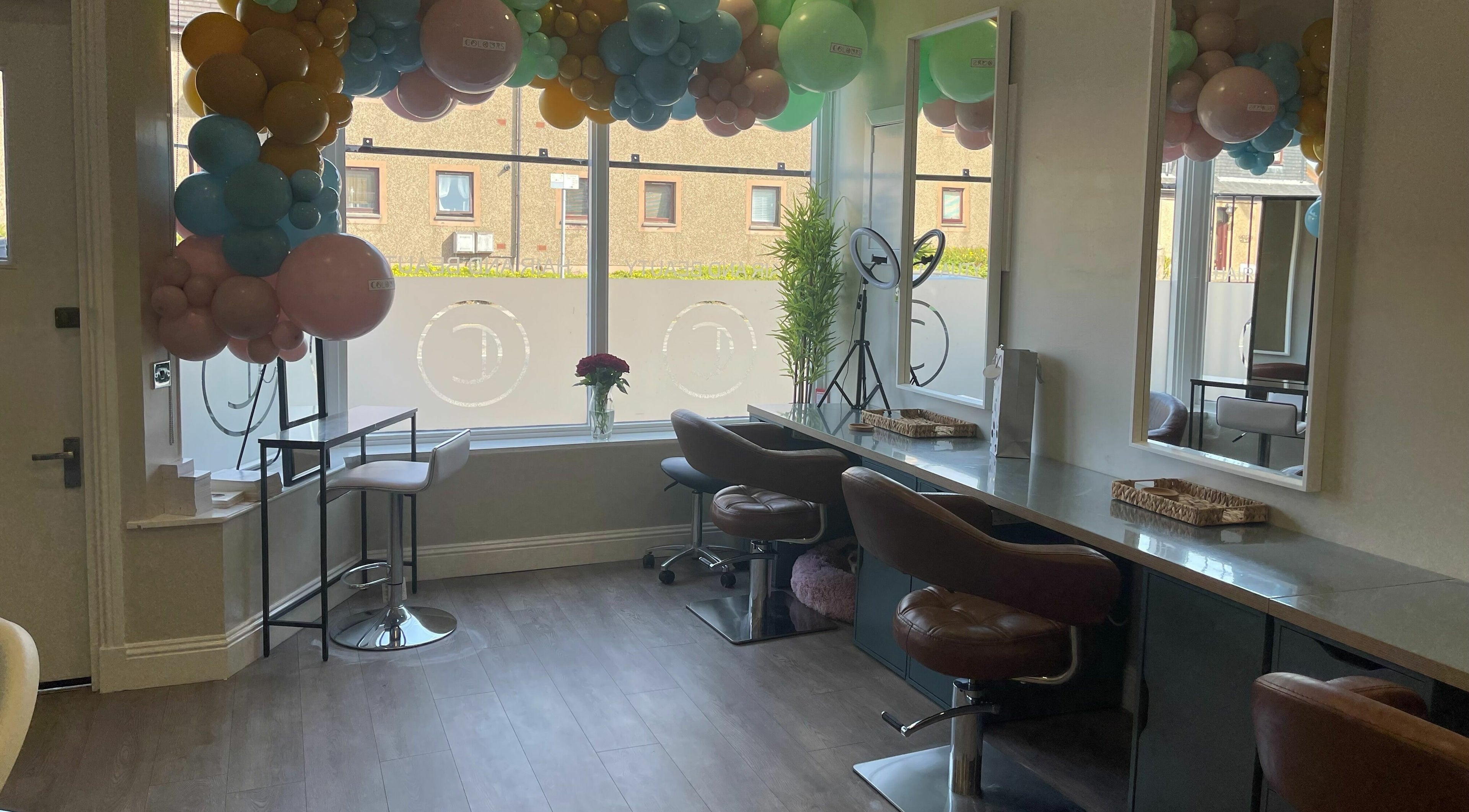 Modern salon interior at Colours Falkirk, Falkirk, Scotland, GB, featuring chic chairs and large windows.
