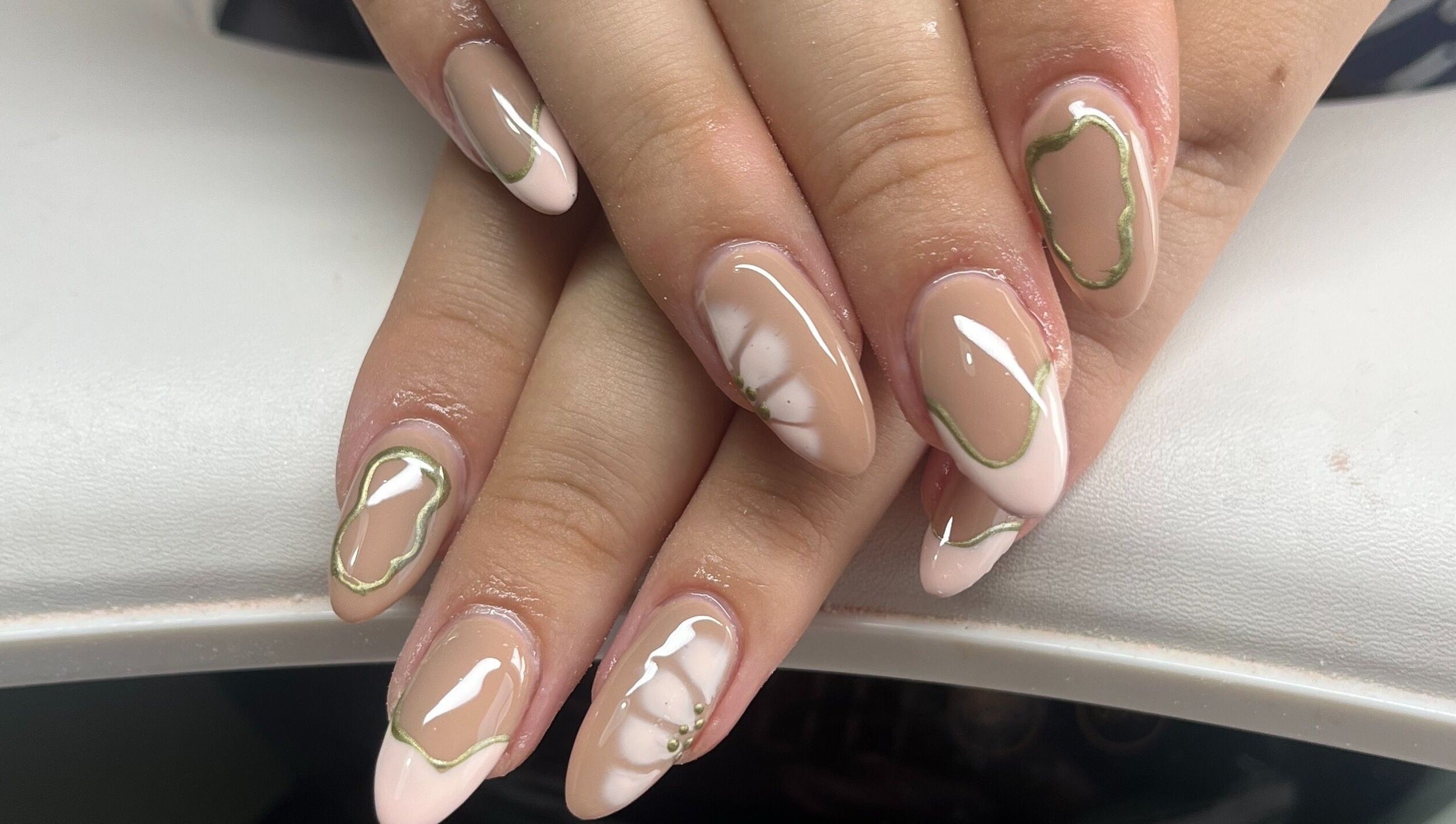 Stylish nail art design at Claire’s Nails and Spray Tans, Colchester, GB featuring nude and white colors.