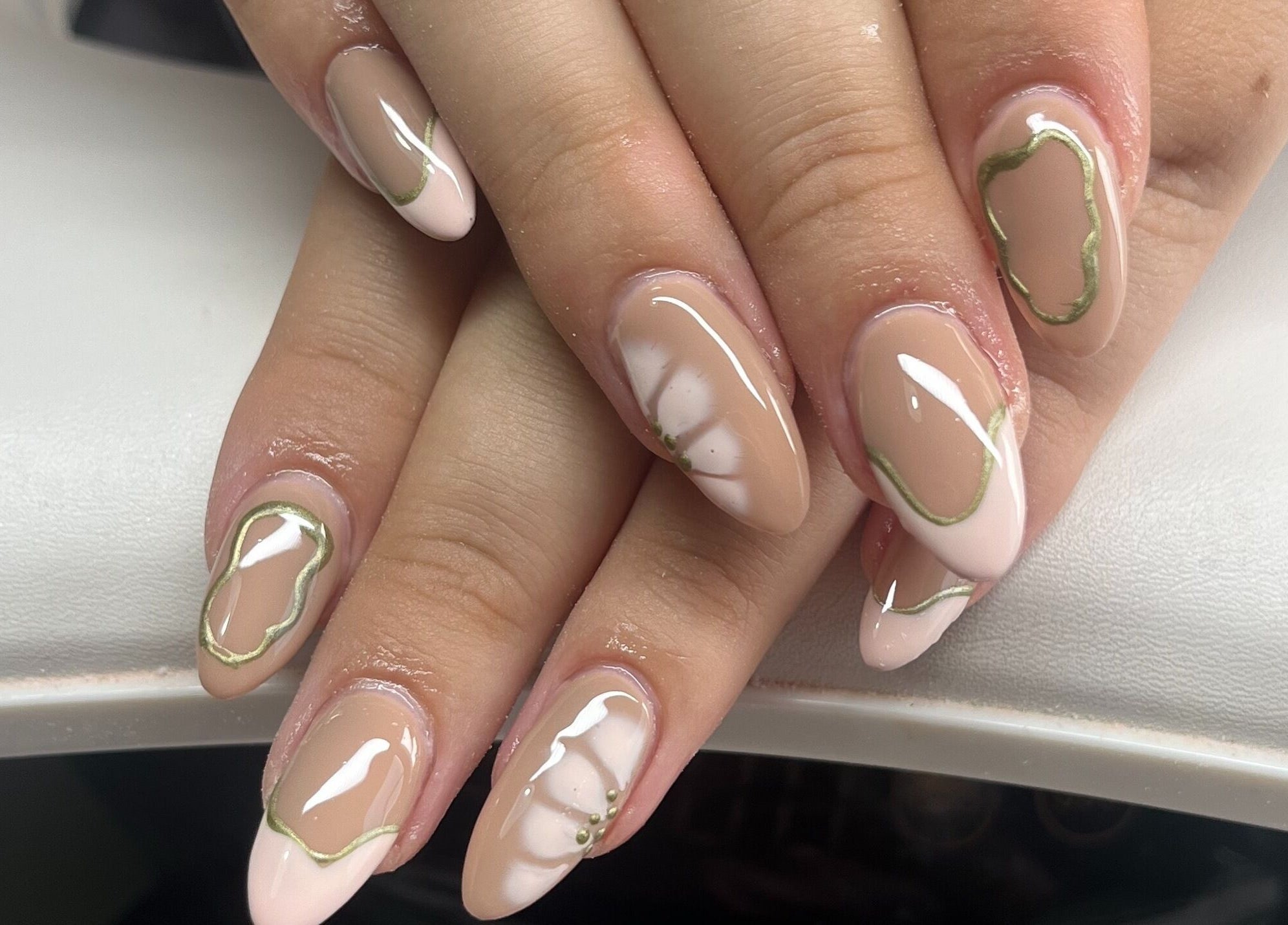 Stylish nail art design at Claire’s Nails and Spray Tans, Colchester, GB featuring nude and white colors.