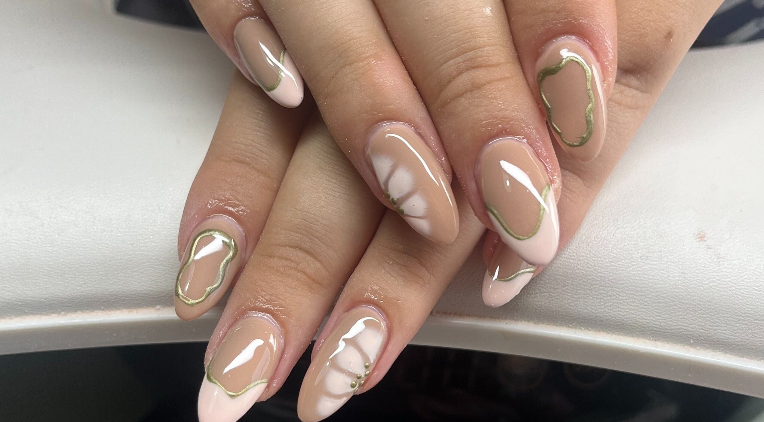 Stylish nail art design at Claire’s Nails and Spray Tans, Colchester, GB featuring nude and white colors.