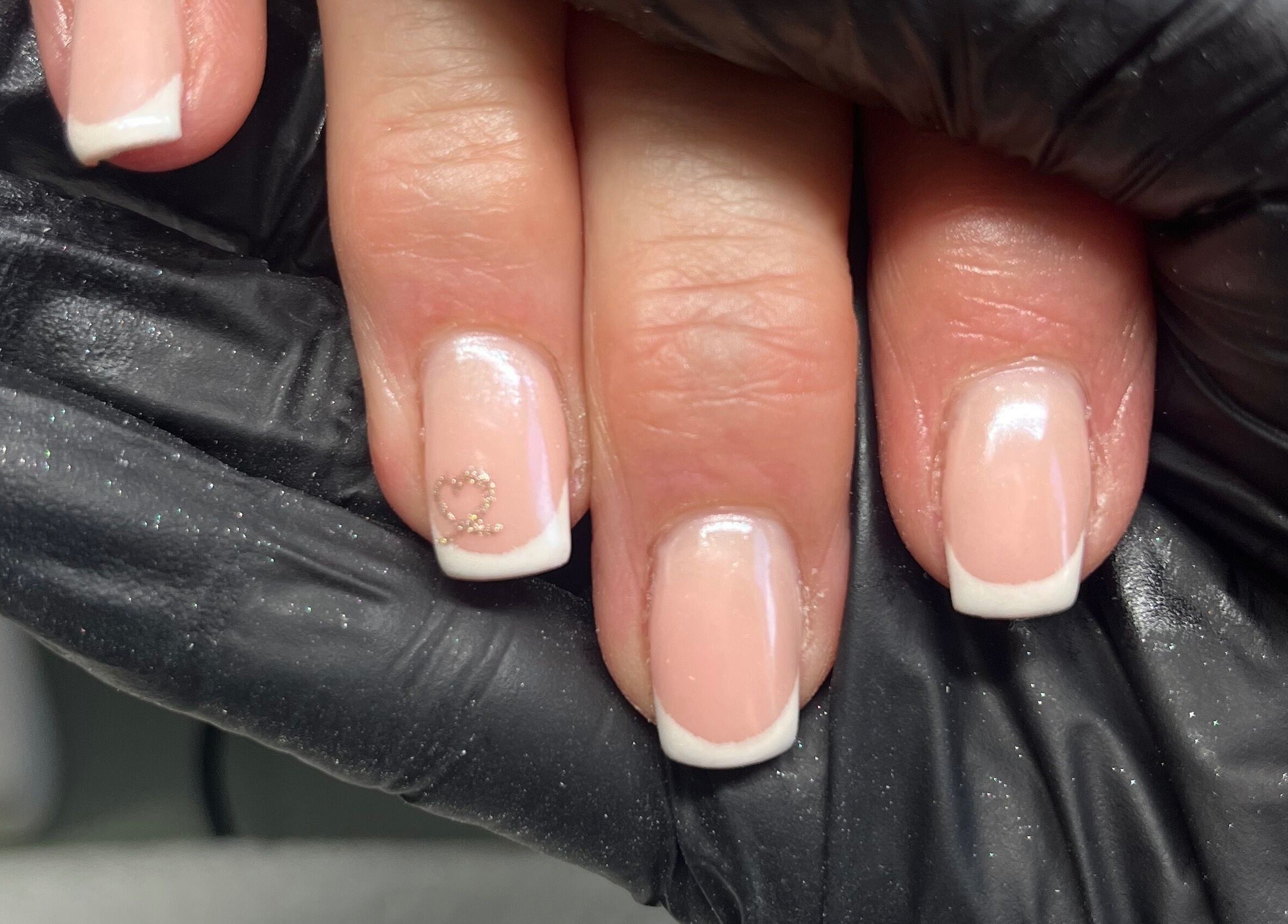 French manicure with heart design at Claire’s Nails and Spray Tans, Colchester, GB.