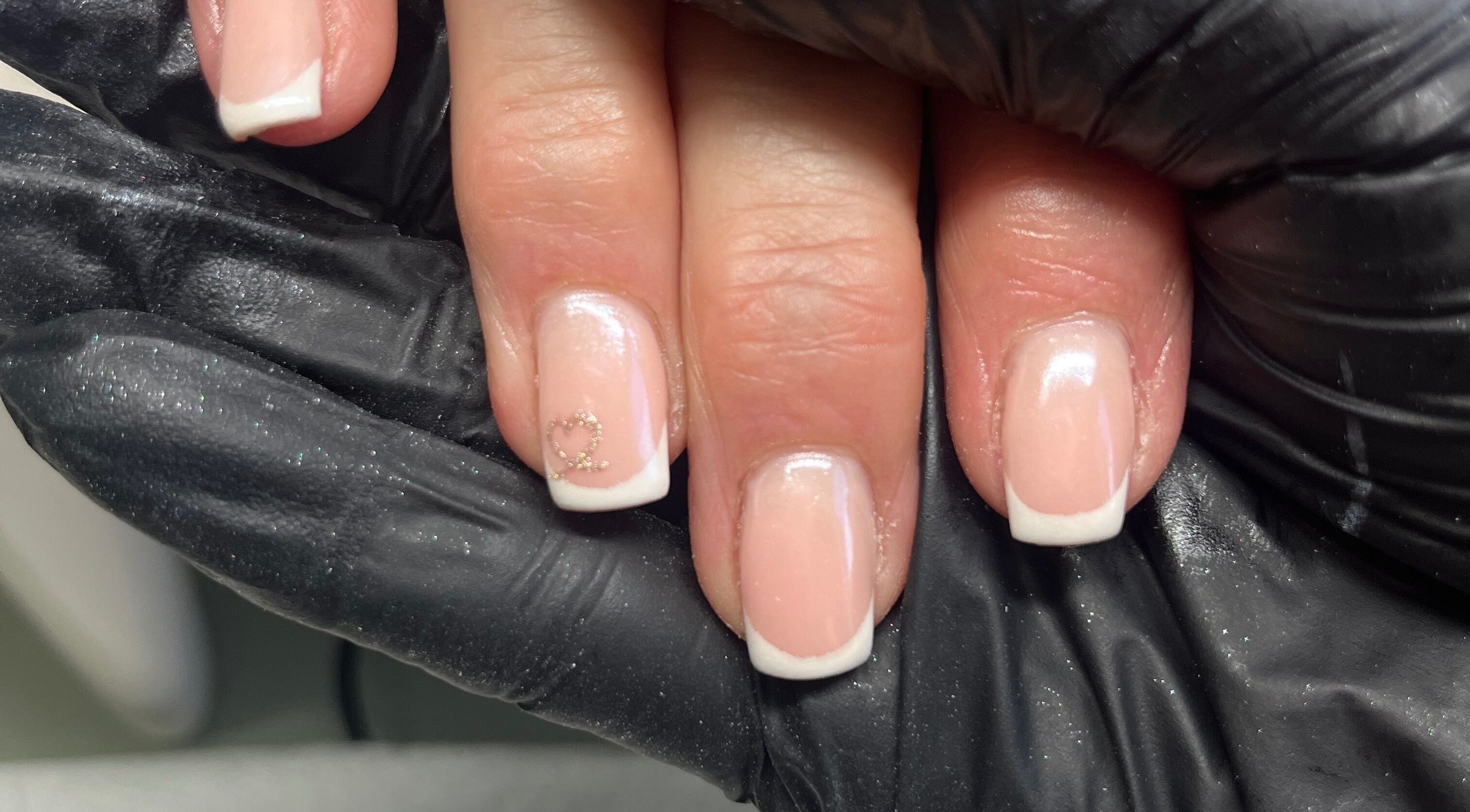 French manicure with heart design at Claire’s Nails and Spray Tans, Colchester, GB.