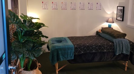 Calming massage room at Knotless in Flex Fitness Taupo, Taupō, Waikato Region, NZ with lush plants and cozy decor.