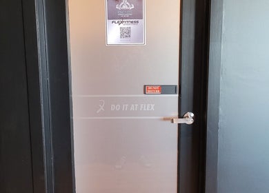 Frosted door with 'Do It At Flex' sign at Knotless Massage, Taupō, Waikato Region, NZ.