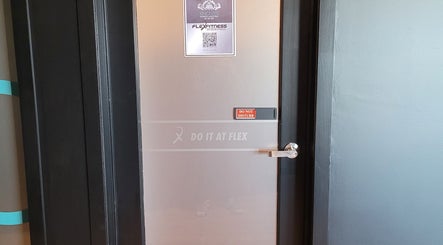 Frosted door with 'Do It At Flex' sign at Knotless Massage, Taupō, Waikato Region, NZ.