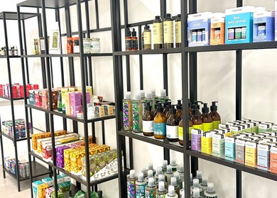 Organized wellness products displayed on shelves at Cupping Clinic, London, England, GB.