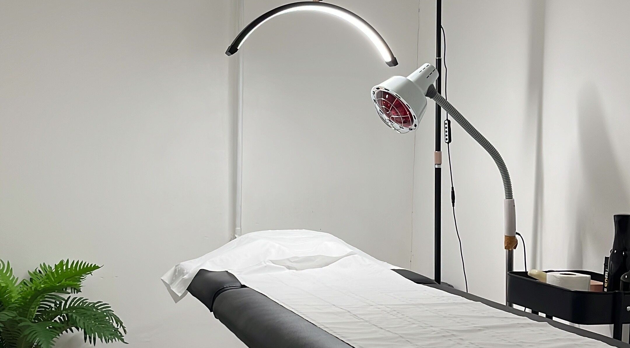 Cupping Clinic treatment room in London, England, GB with massage table and modern equipment.