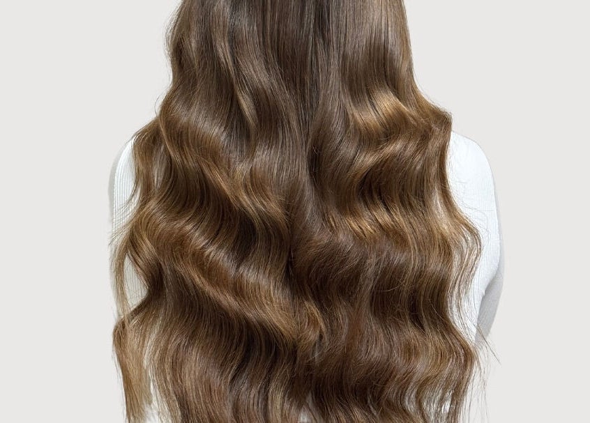 Luxurious long wavy hair styled at The Extension Haven, St. Thomas, Ontario, CA, showcasing rich, silky texture.