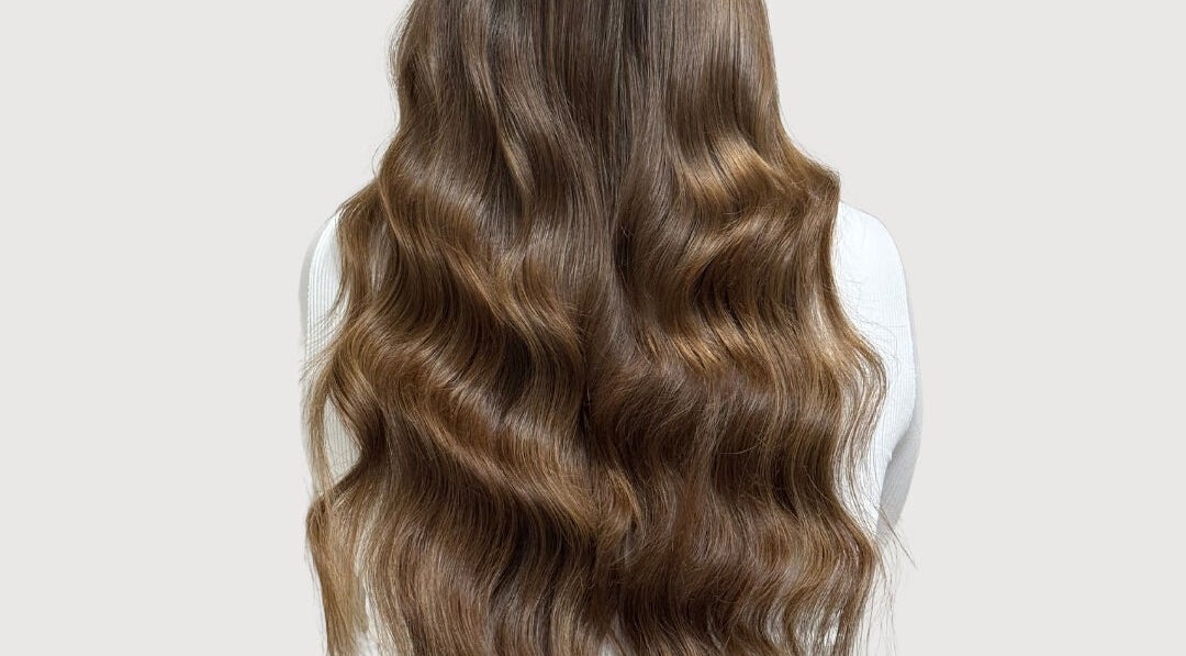 Luxurious long wavy hair styled at The Extension Haven, St. Thomas, Ontario, CA, showcasing rich, silky texture.