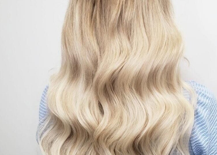 Long, wavy blonde hair styled beautifully at The Extension Haven, St. Thomas, Ontario, CA.