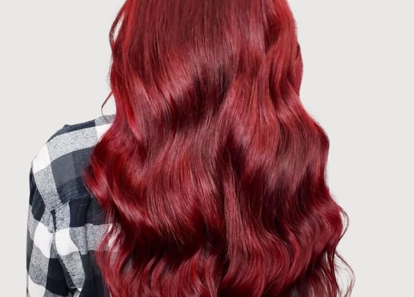 Lustrous crimson hair waves at The Extension Haven, St. Thomas, Ontario, CA, showcasing vibrant color expertise.