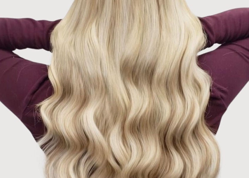 Luxurious blonde hair extensions at The Extension Haven, St. Thomas, Ontario, CA offering stunning waves.