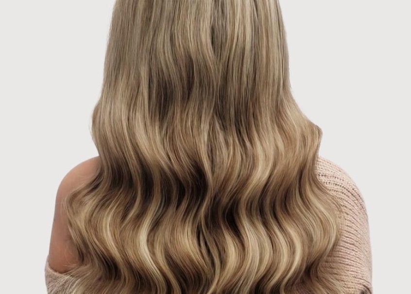 Long, wavy blonde hair styled at The Extension Haven, St. Thomas, Ontario, CA.
