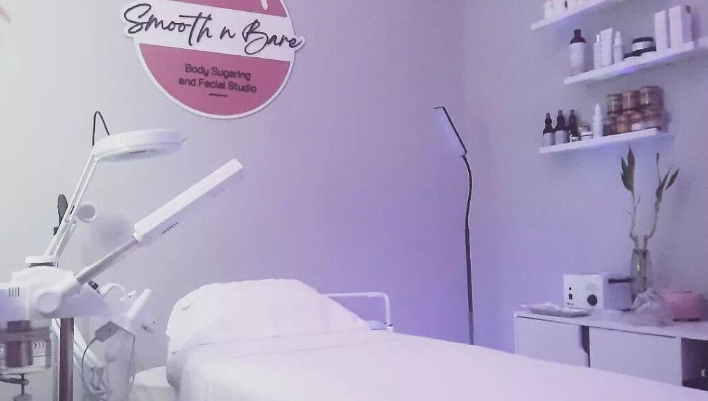 Calming treatment room at Smooth n Bare, Kingston, St. Andrew Parish, JM, featuring a therapy bed and soft lighting.