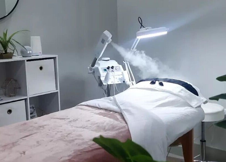 Calm treatment room at Smooth n Bare, Kingston, St. Andrew Parish, JM featuring a comfortable bed and modern equipment.
