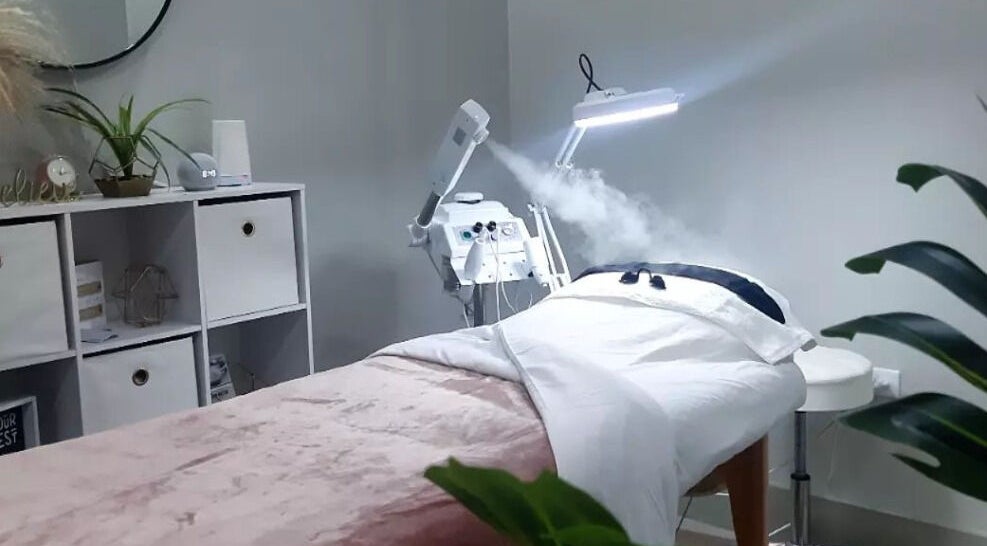 Calm treatment room at Smooth n Bare, Kingston, St. Andrew Parish, JM featuring a comfortable bed and modern equipment.